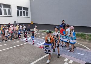Policjantka z dziećmi na terenie mobilnego miasteczka rowerowego