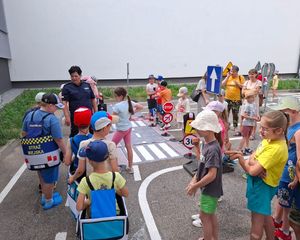 Policjantka z dziećmi na mobilnym miasteczku rowerowym