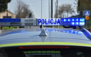 Belka policyjnego radiowozu z włączonymi sygnałami świetlnymi