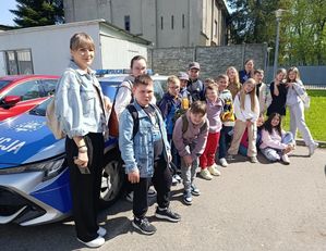 Zdjęcie grupowe dzieci przy radiowozie
