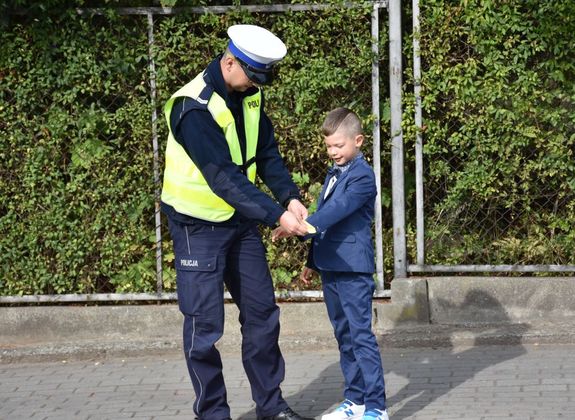 Policjant daje odblask dziecku