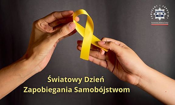 Grafika odnosząca się do Światowego Dnia Zapobieganiu Samobójstwom. Plakat przedstawia dłonie z żółta wstążką