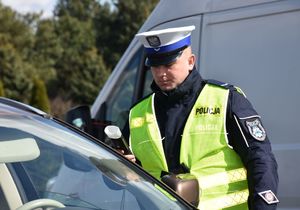 Policjant kontroluje stan trzeźwości kierującego samochodem