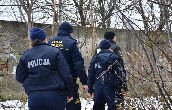 Policjantka i Strażnicy Miejscy w trakcie kontroli pustostanu