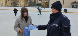 Policjantka daje dziecku ulotkę