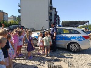 Policjantka z dziećmi przy radiowozie